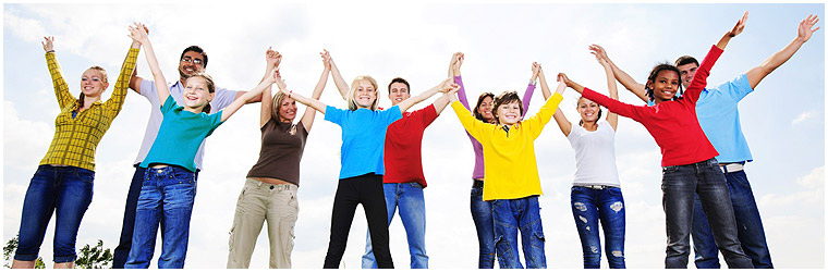 group of people in colorful shirts raising arms
