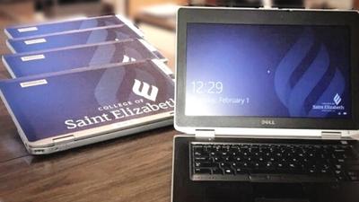 Image of laptops with College of Saint Elizabeth logo on cover