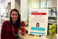 Woman standing in front of Center for Nutrition Poster at SEU