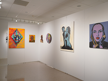 Multiple paintings from the Figures and Faces exhibit